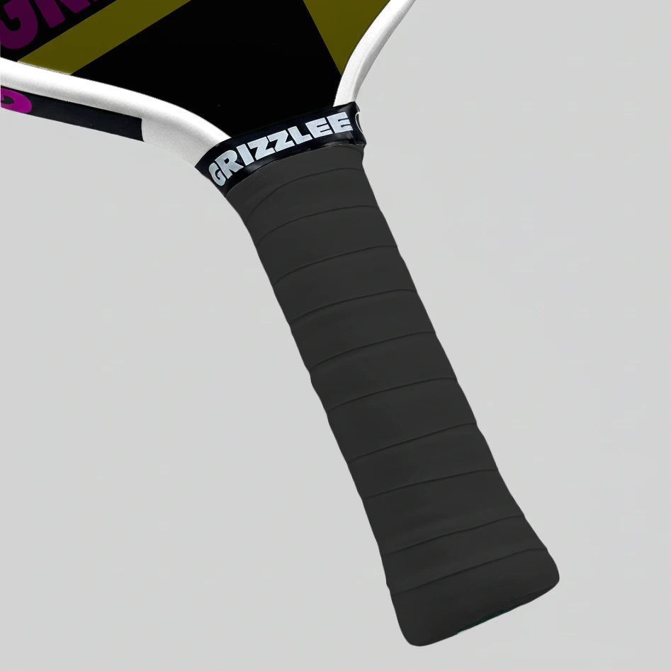 Close-up of a black pickleball paddle grip with 'Grizzlee' branding on a gray background