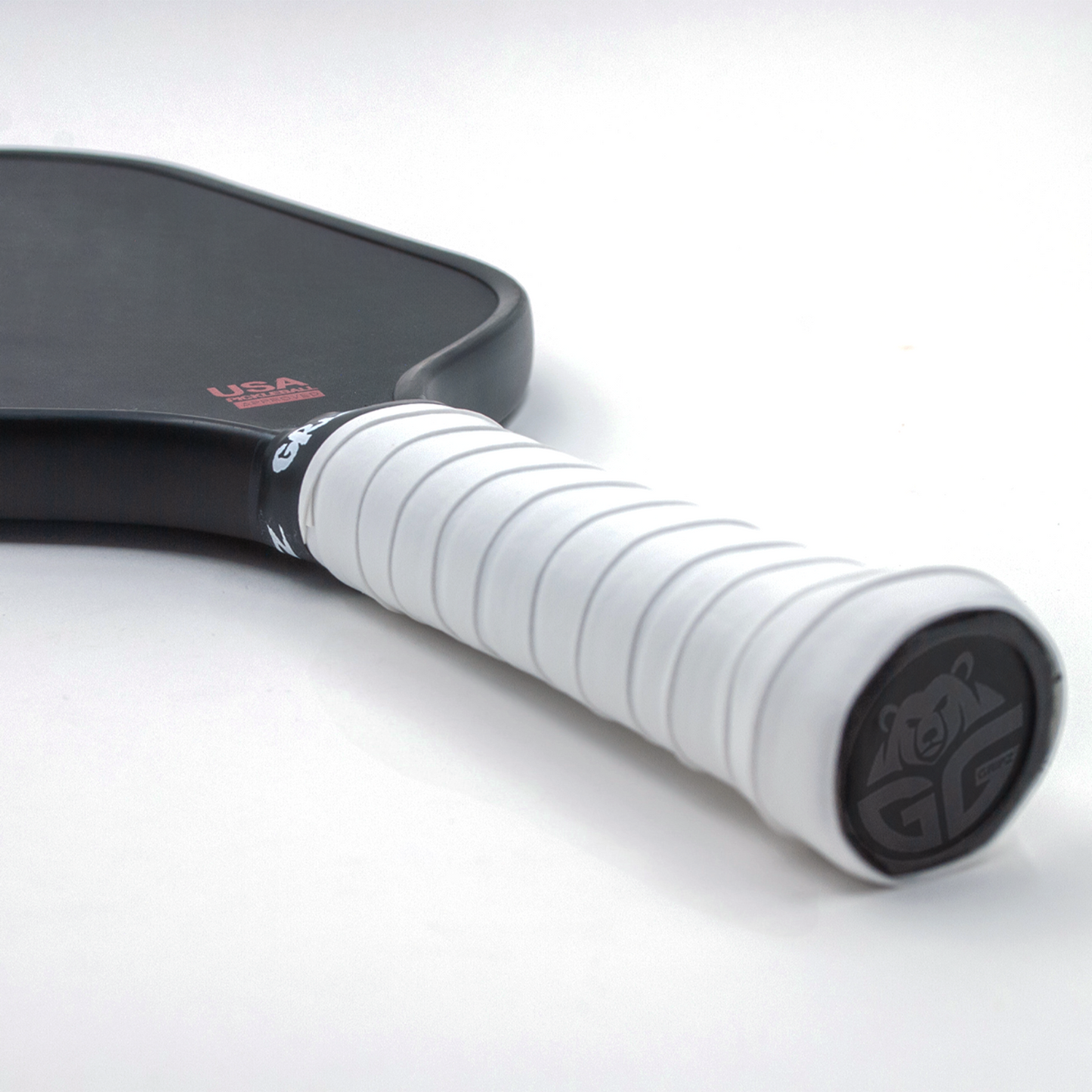 Bright white Grizzlee Gripz wrapped around  a paddle handle - Premium Pickleball Overgrip by Grizzlee Gripz