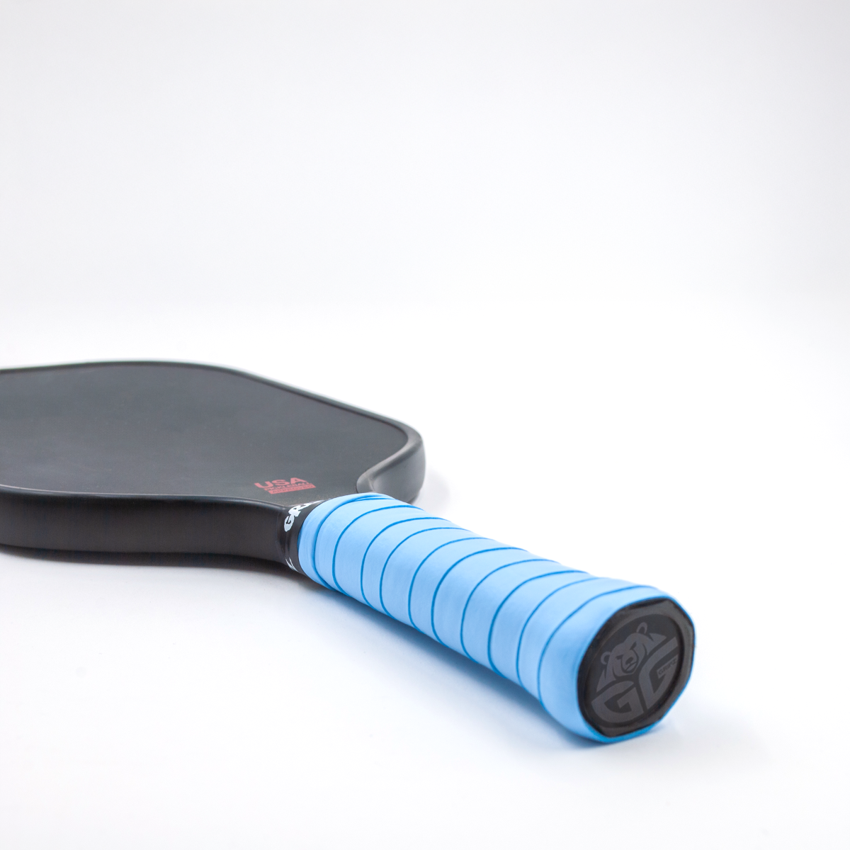 light blue grizzlee gripz overgrips on a paddle - Premium Pickleball Overgrip by Grizzlee Gripz