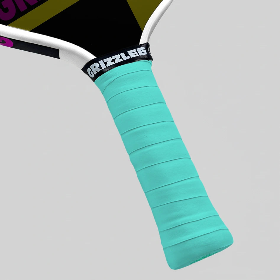 Pickleball paddle with a sapphire green grip and 'Grizzlee' branding on a gray background