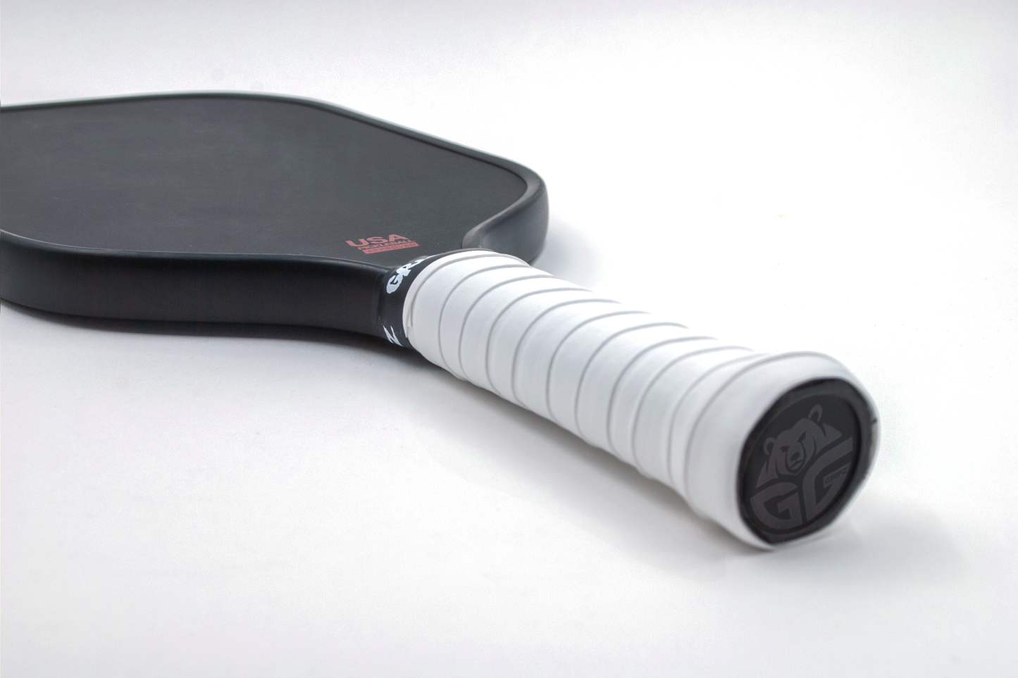 bright white grizzlee gripz overgrip wrapped on a pickleball paddle laying down flat - Premium Pickleball Overgrip by Grizzlee Gripz